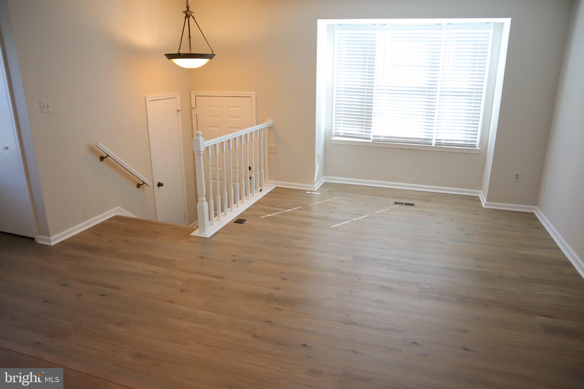 10848 Douglas Avenue Silver Spring, MD 20902 - Photo 4 of 33 an empty room with wooden floor and window