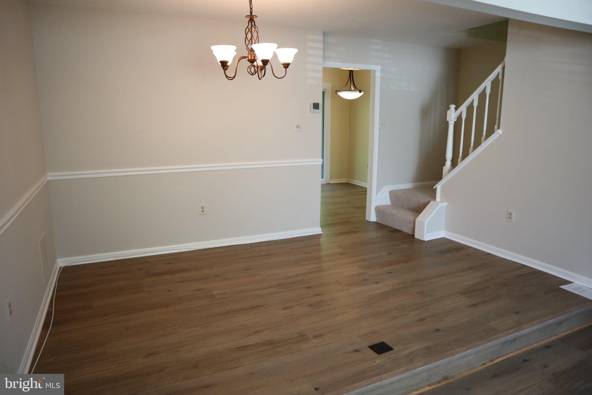 10848 Douglas Avenue Silver Spring, MD 20902 - Photo 6 of 33 wooden floor in an empty room with a window