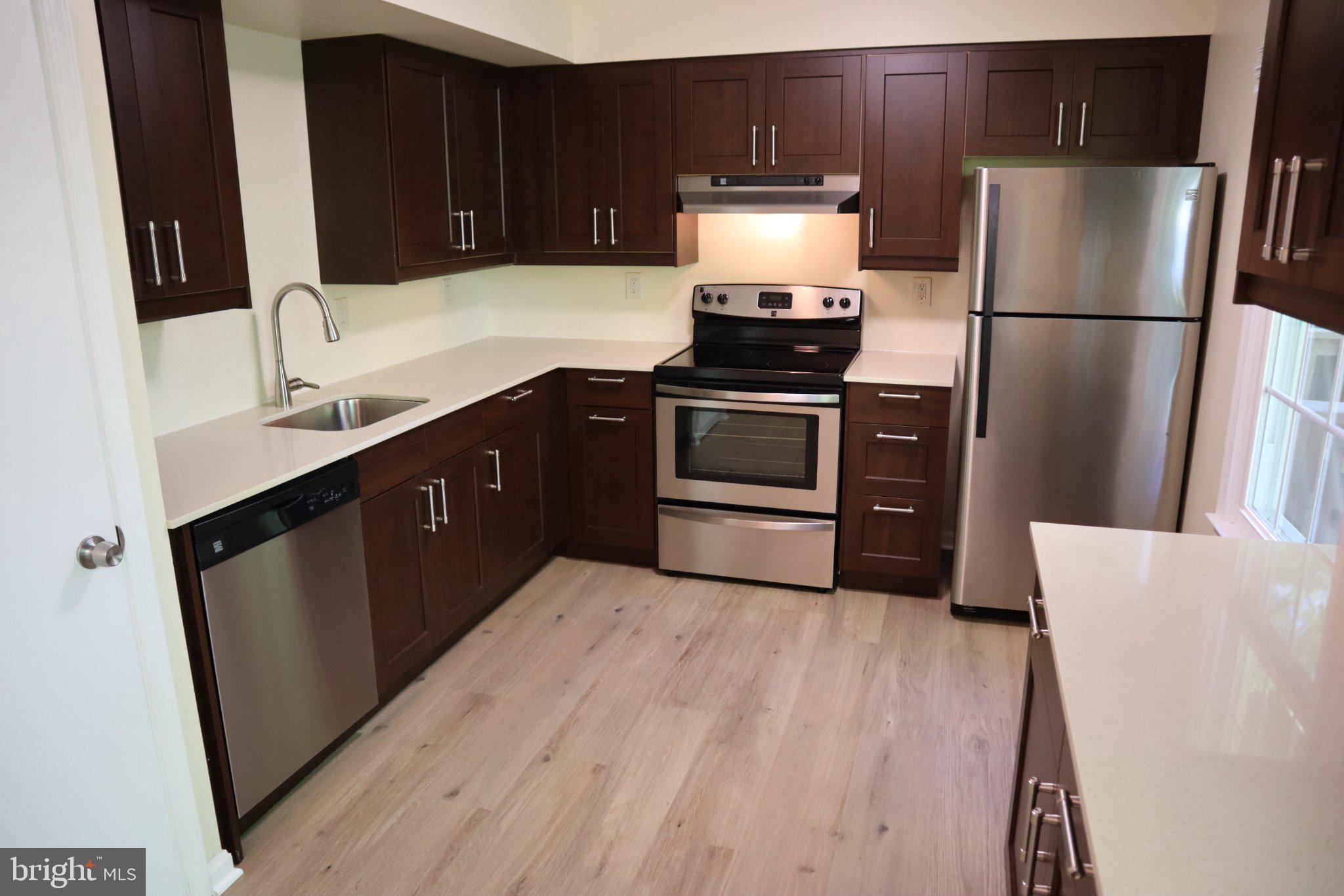 10848 Douglas Avenue Silver Spring, MD 20902 - Photo 8 of 33 a kitchen with a refrigerator sink and stove
