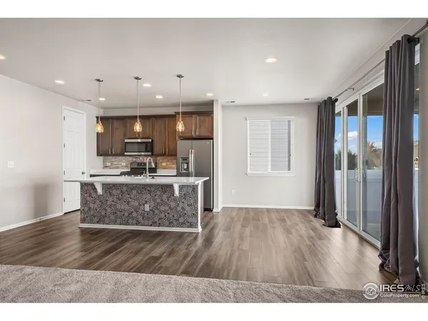 a view of kitchen with cabinets microwave and stove