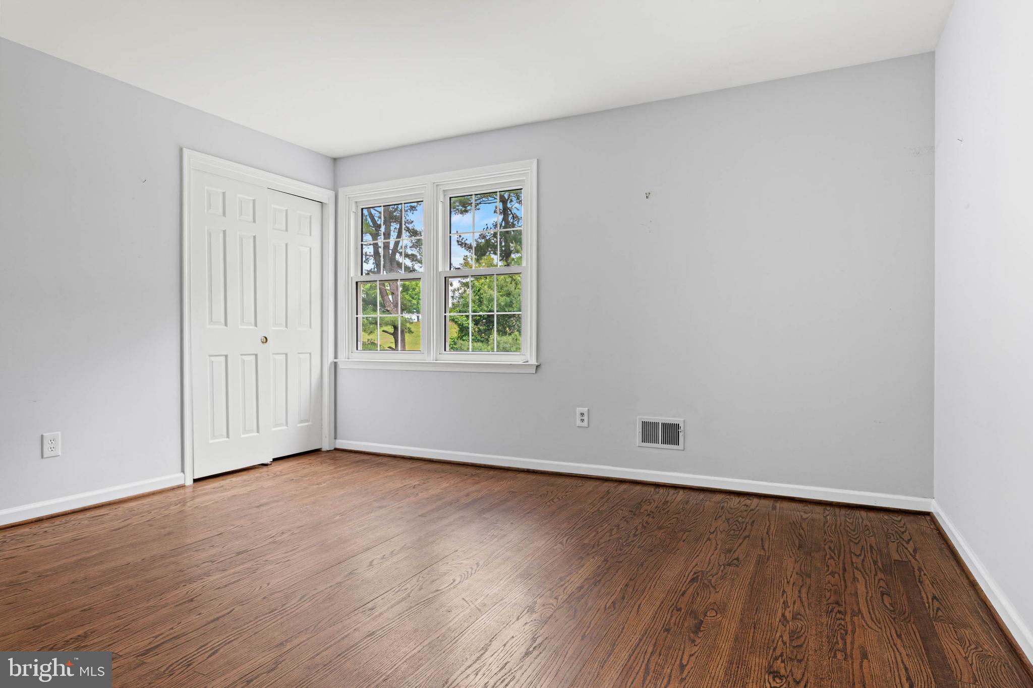 533 Gulph Road Wayne, PA 19087 - Photo 24 of 43 an empty room with wooden floor and windows