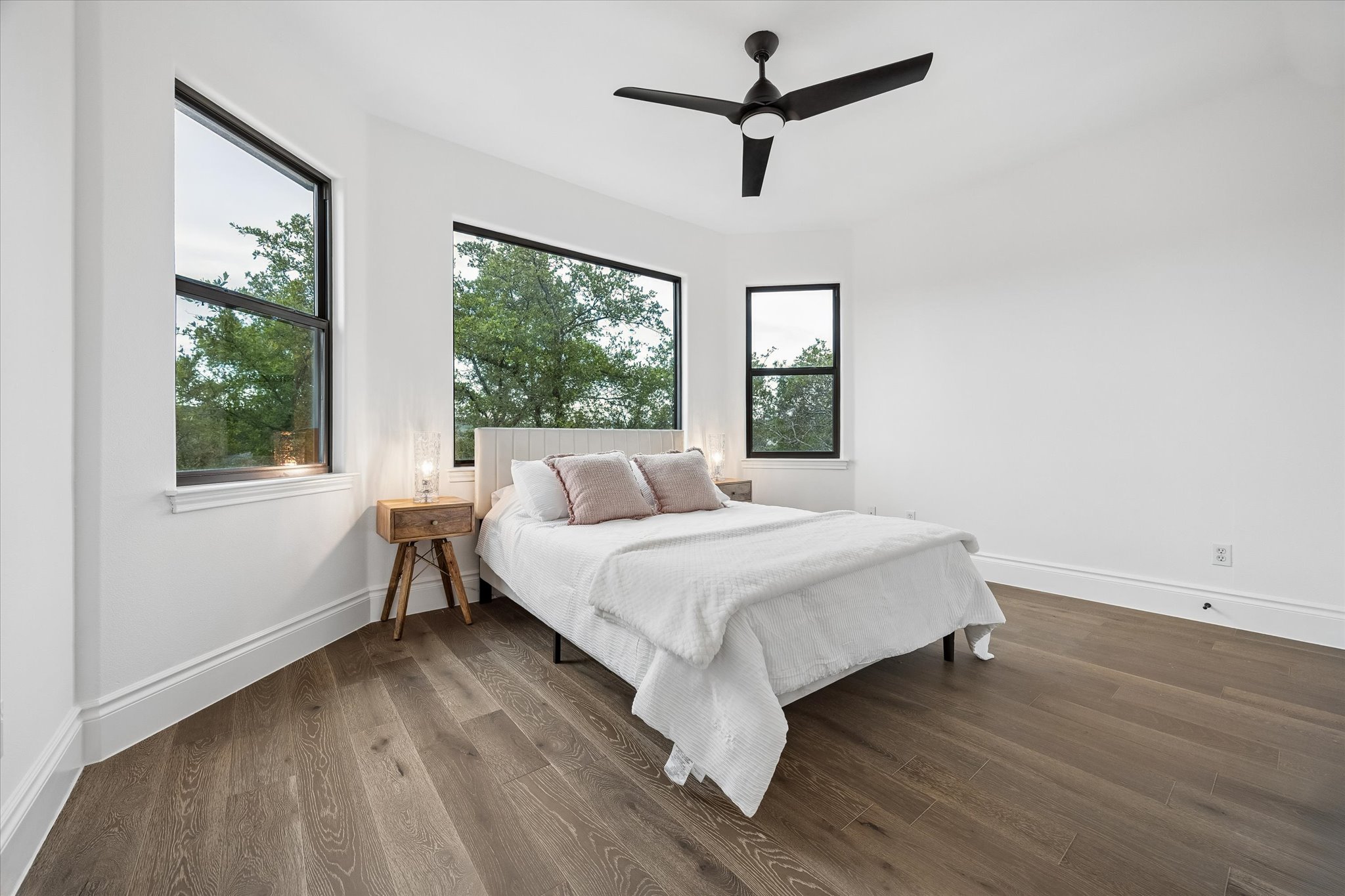 3719 Bee Creek Road Spicewood, TX 78669 - Photo 21 of 40 Floor-to-ceiling windows illuminate this airy bedroom, offering verdant outdoor views.