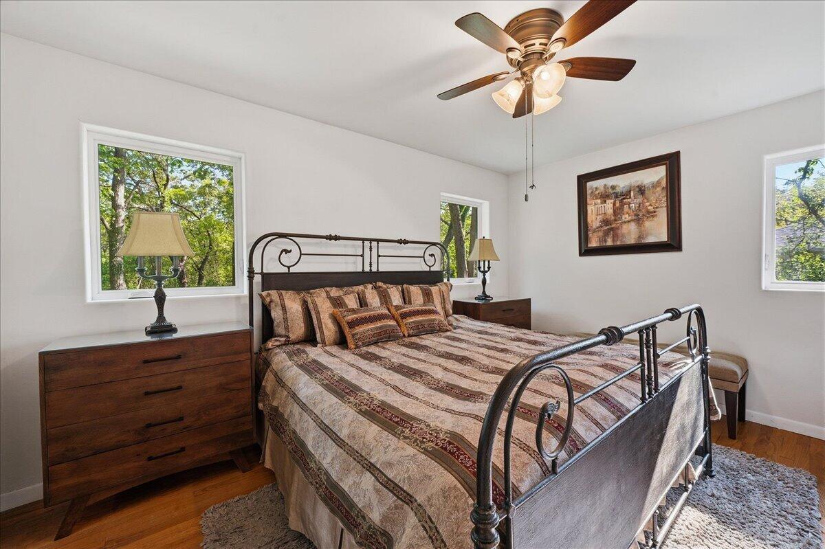 63 Ski Hill Road Portage, IN 46368 - Photo 15 of 28 a bedroom with a bed and a chandelier