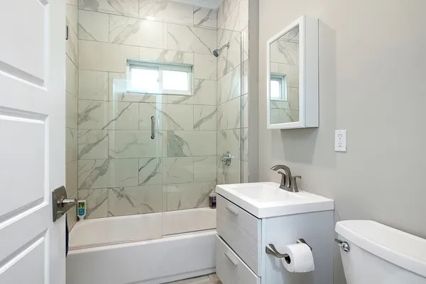 a bathroom with a sink a toilet and bathtub