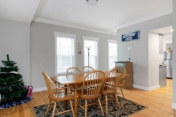 a view of a dining room with furniture and wooden floor