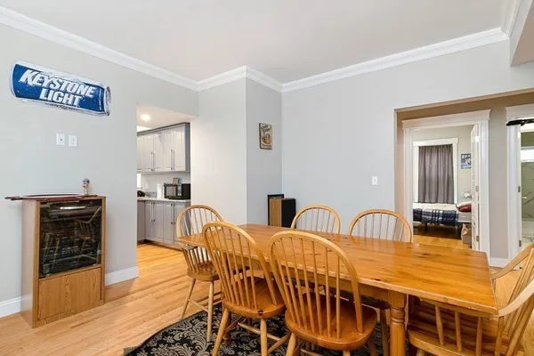 a view of a dining room with furniture and wooden floor