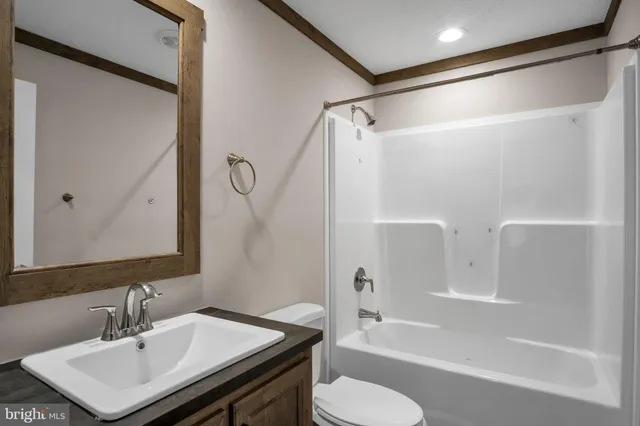 a bathroom with a bathtub shower sink and a toilet