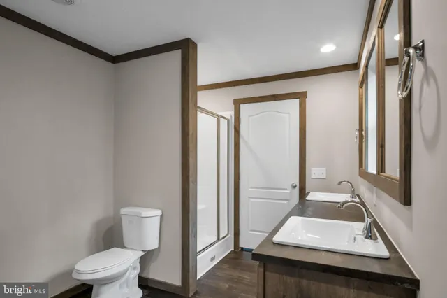 a bathroom with a toilet sink and a mirror