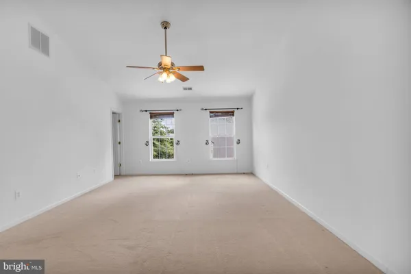 a view of hallway with wooden floor and stairs