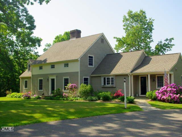 150 Eabow Brook Road Bridgewater, CT 06752 - Photo 1 of 1 a front view of a house with a garden and trees