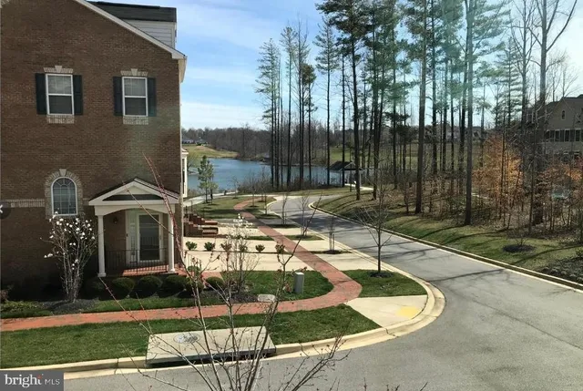 a patio with table and chairs and potted plants