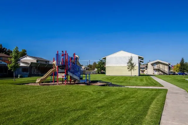 a view of a park with houses