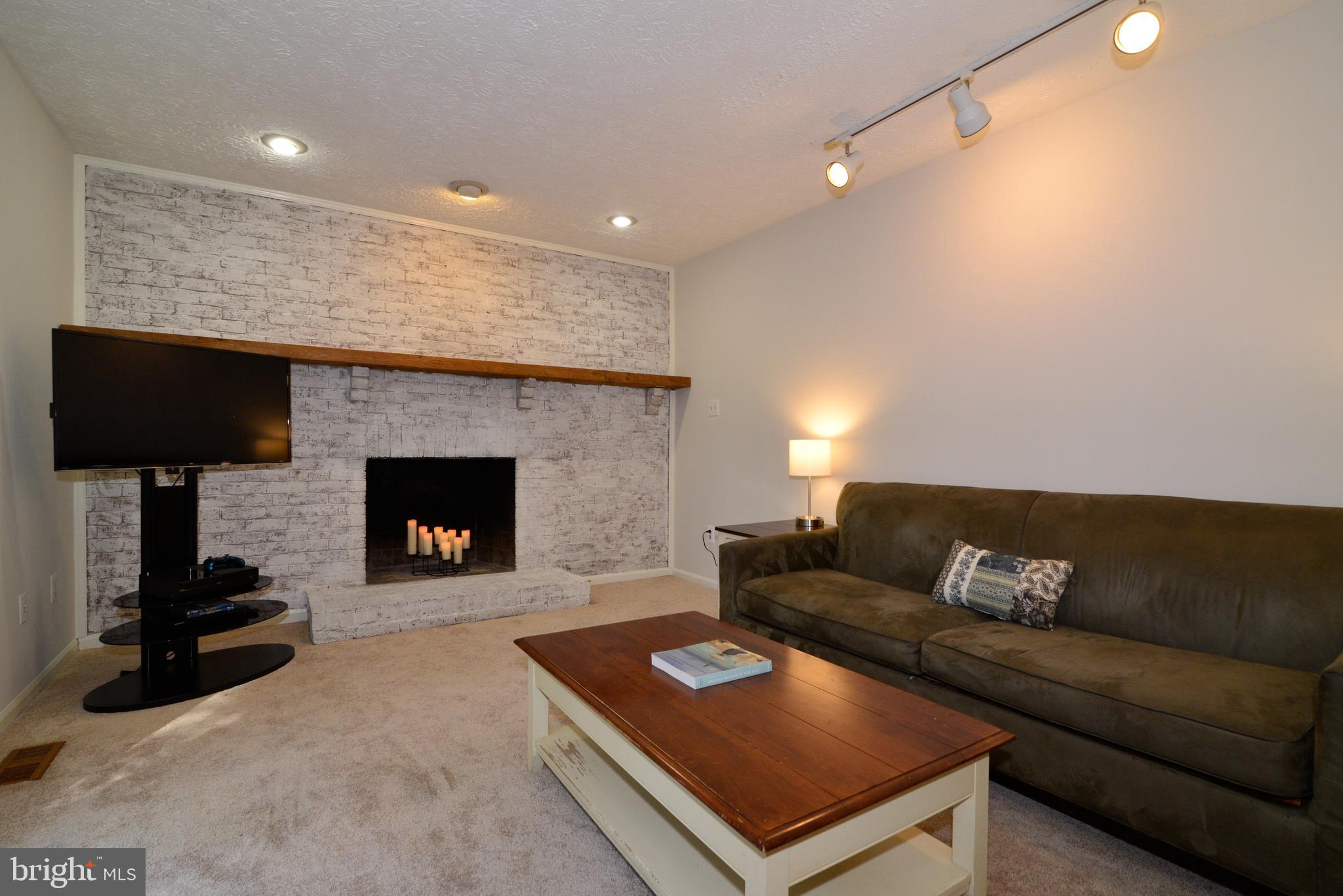 1494 Coat Ridge Road Herndon, VA 20170 - Photo 10 of 37 Family room with wood-burning fireplace