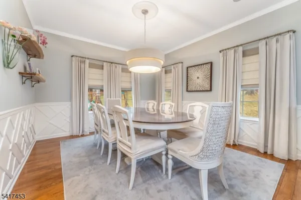 a view of a dining room with furniture and window