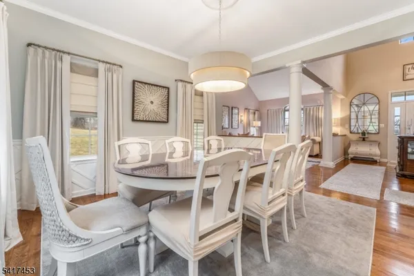 a view of a dining room with furniture and a chandelier