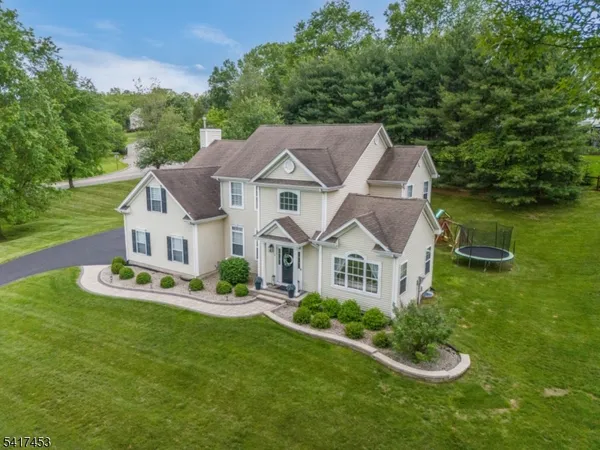a front view of a house with a yard table and chairs
