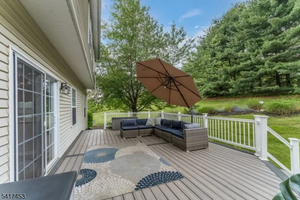 a view of backyard with outdoor seating and green space