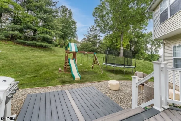 a view of a swimming pool with a patio and a garden