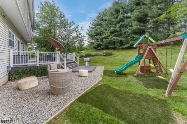 a view of a house with backyard and sitting area