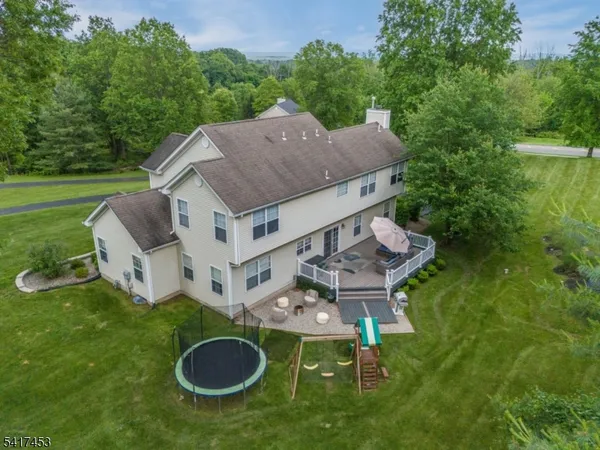 an aerial view of a house with table and chairs and a yard