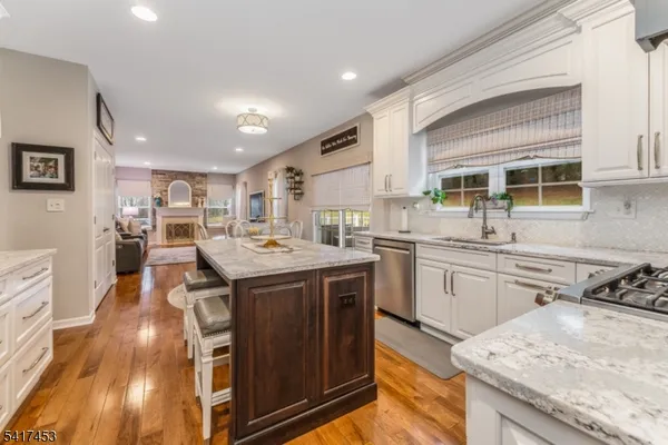 a kitchen with a stove sink and cabinets