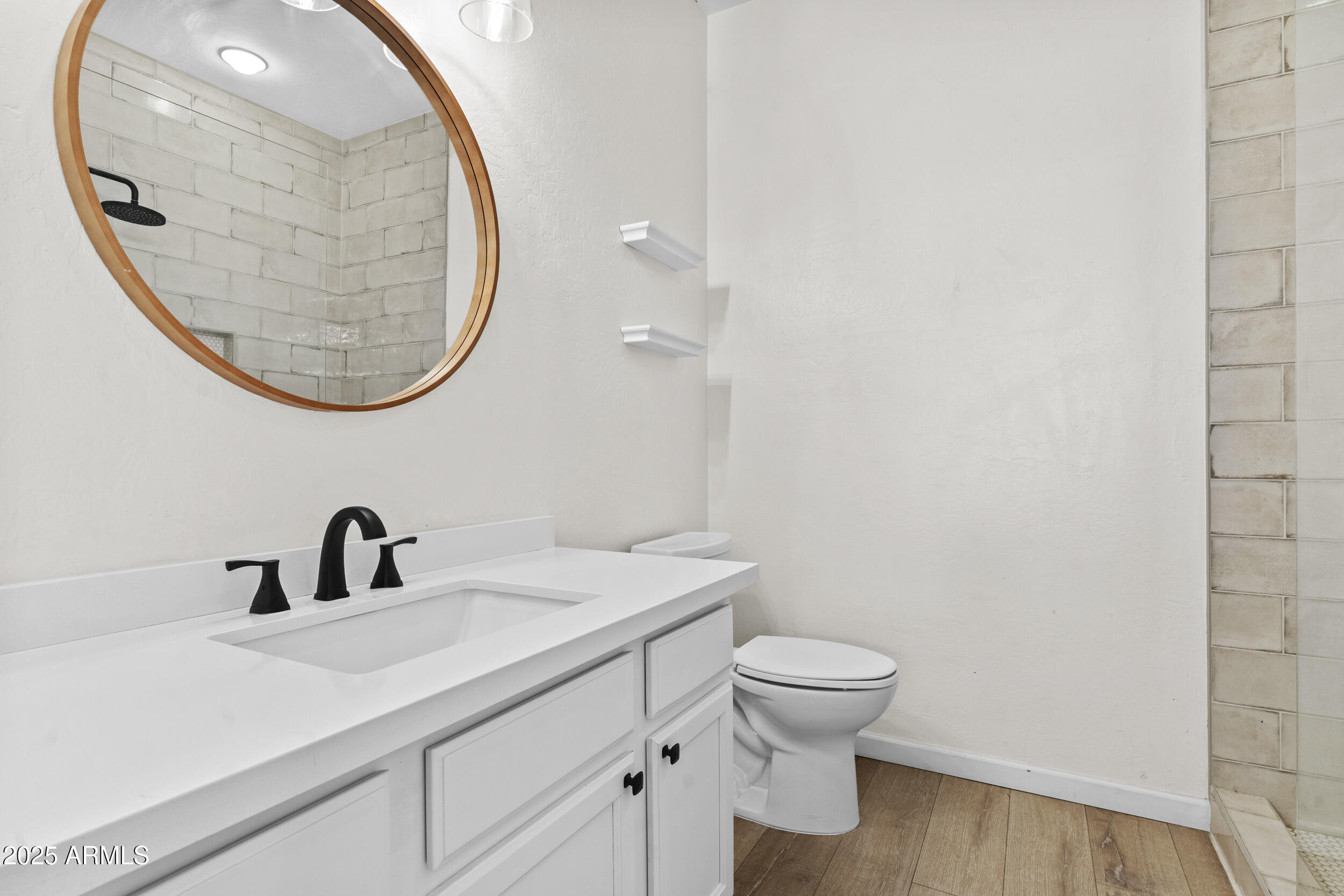 1225 North 36th Street, Unit 1015 Phoenix, AZ 85008 - Photo 14 of 22 a bathroom with a sink a mirror and a toilet