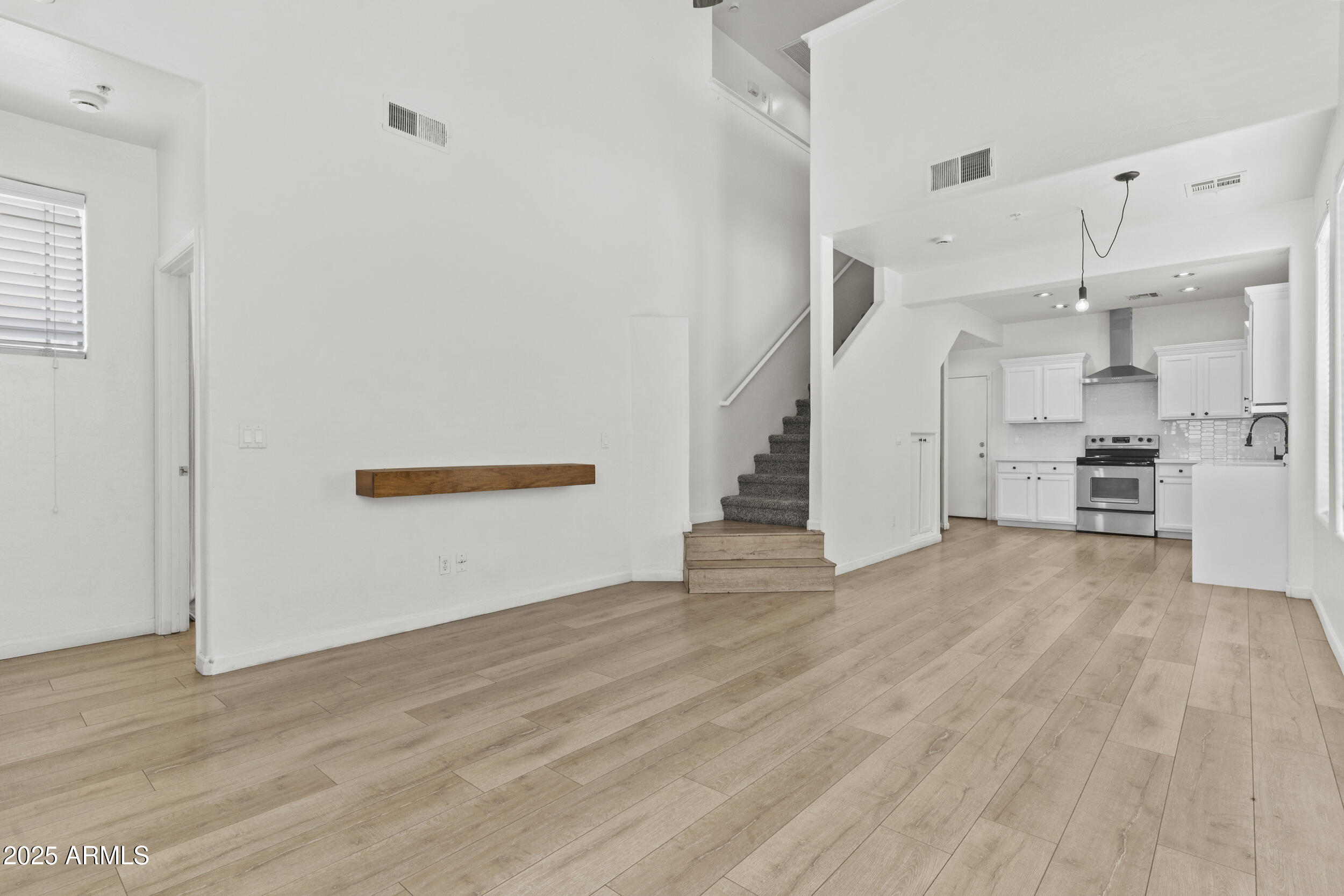 1225 North 36th Street, Unit 1015 Phoenix, AZ 85008 - Photo 6 of 22 a view of empty room with wooden floor