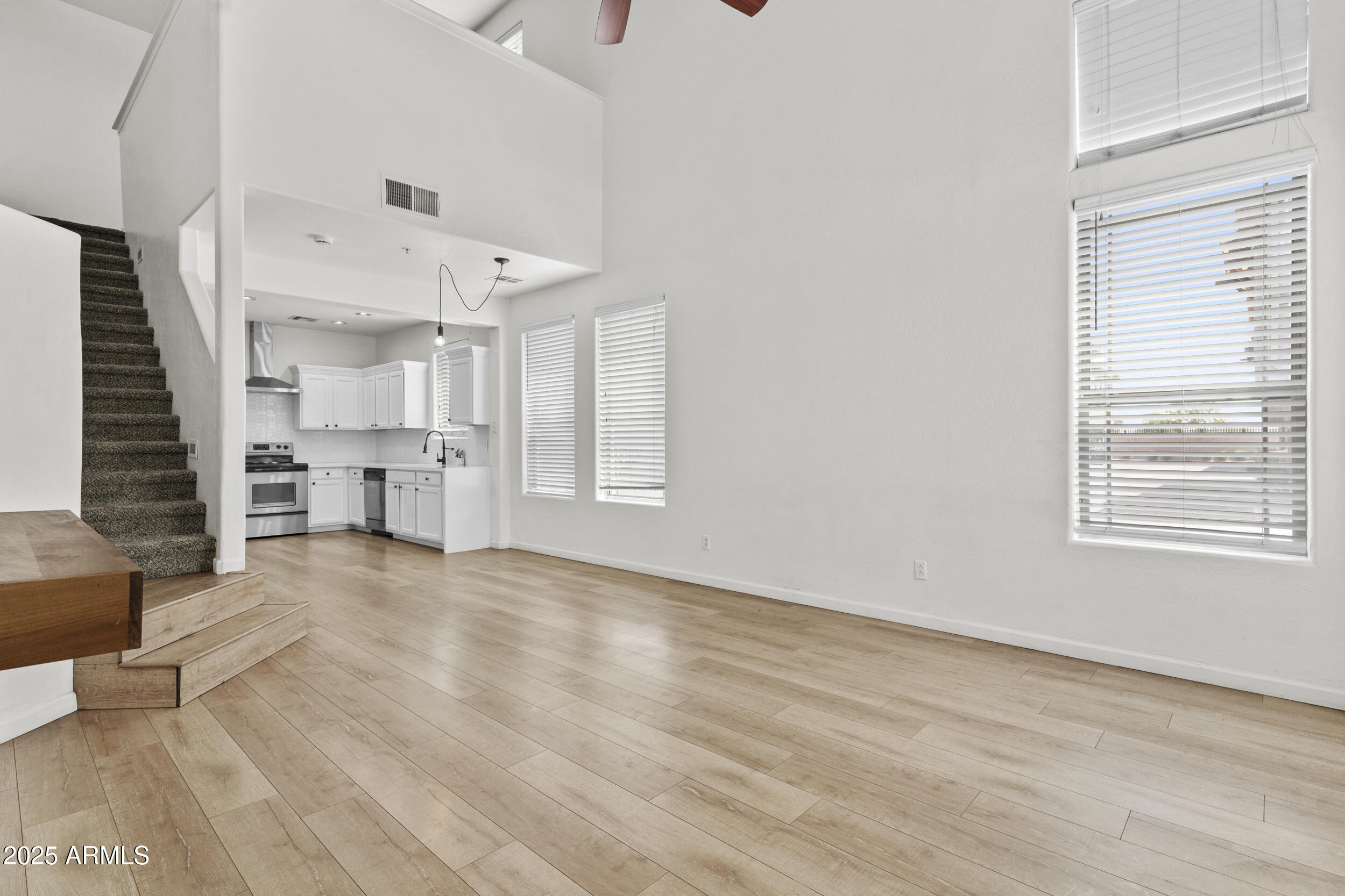 1225 North 36th Street, Unit 1015 Phoenix, AZ 85008 - Photo 7 of 22 a view of empty room with wooden floor and windows
