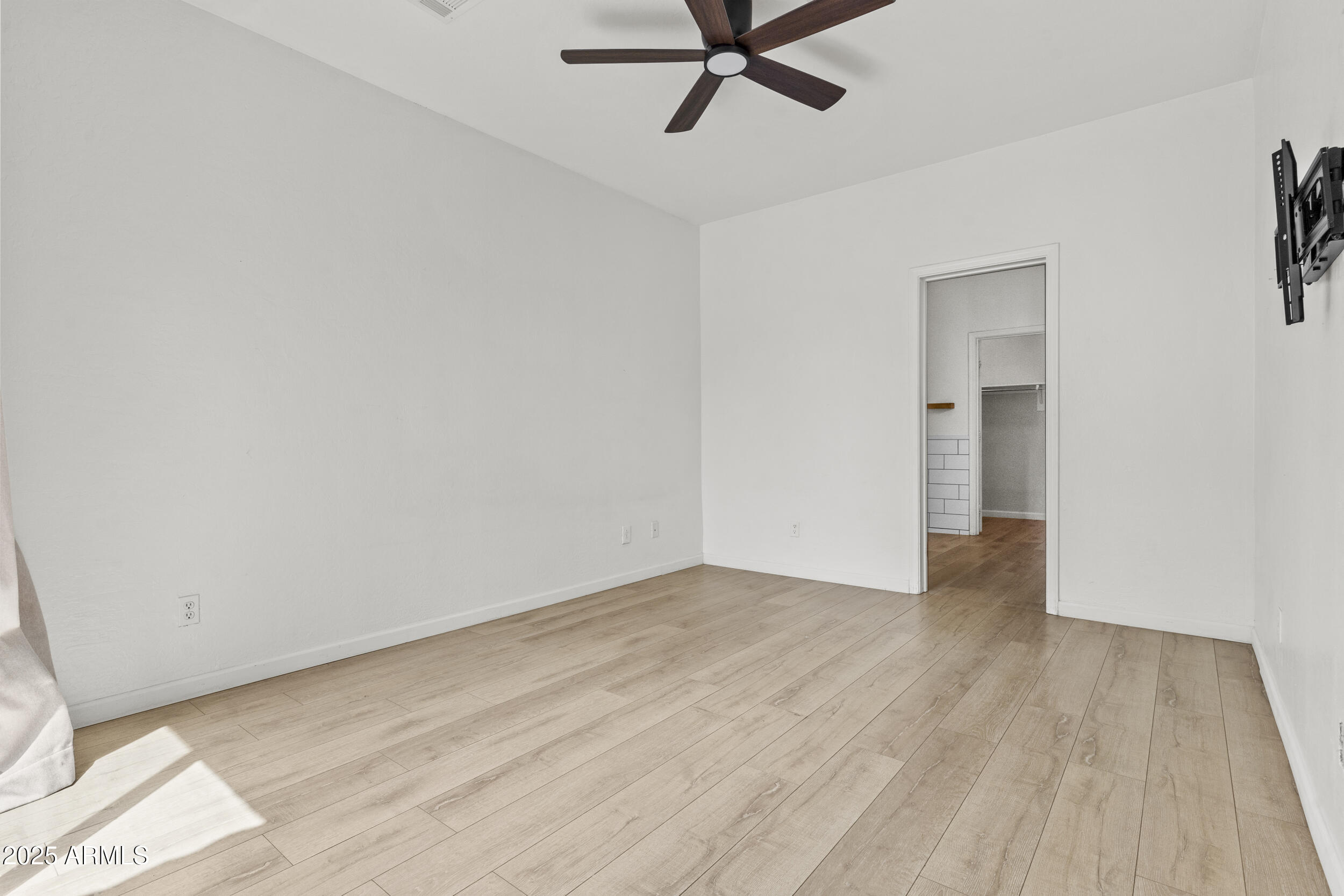 1225 North 36th Street, Unit 1015 Phoenix, AZ 85008 - Photo 8 of 22 a view of a room with wooden floor and ceiling fan