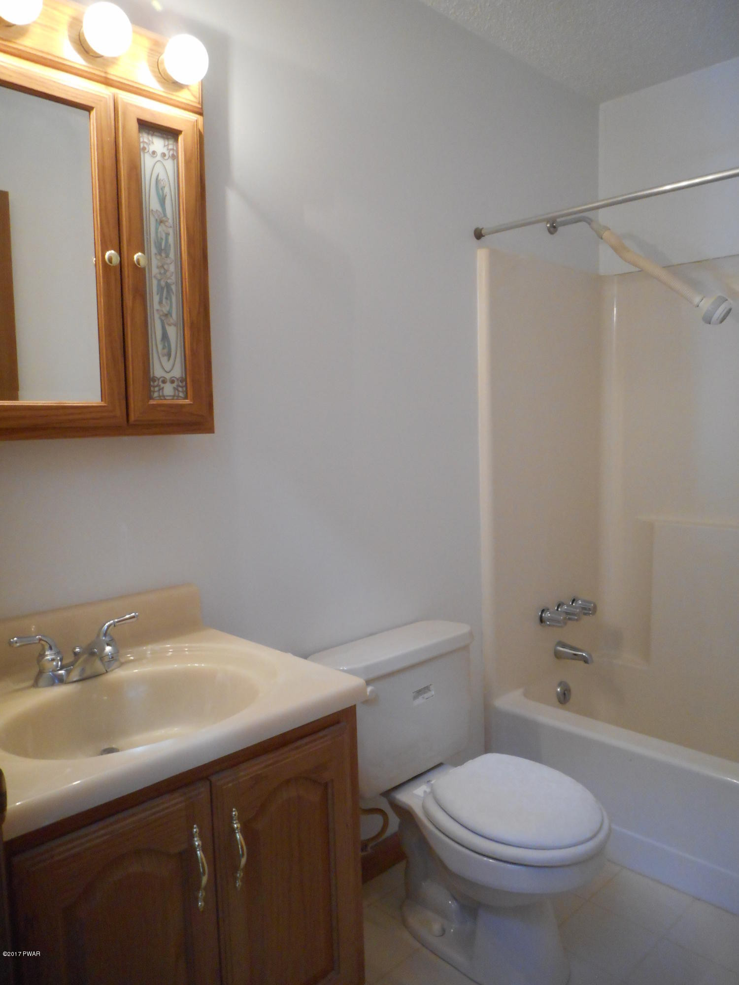 262 High Ridge Road Dingmans Ferry, PA 18328 - Photo 13 of 21 a bathroom with a sink a toilet and shower