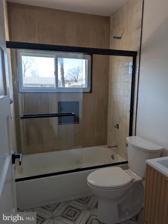a white toilet sitting next to a white sink