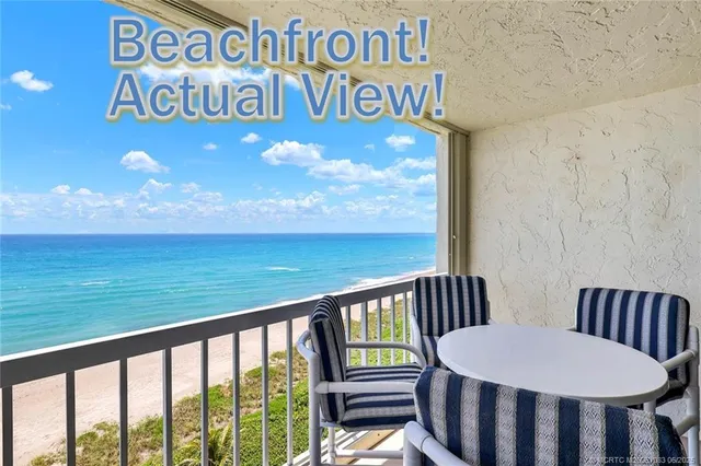 a view of a chairs and table in the balcony