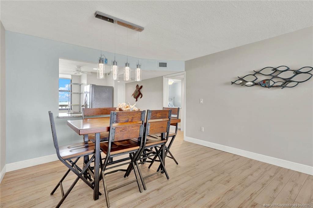 10600 South Ocean Drive, Unit 802 Jensen Beach, FL 34957 - Photo 13 of 39 a view of a dining room with furniture and wooden floor