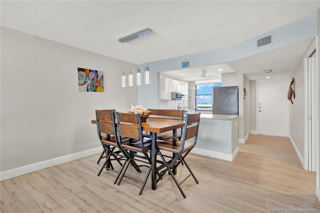 10600 South Ocean Drive, Unit 802 Jensen Beach, FL 34957 - Photo 14 of 39 a dining room with furniture and wooden floor