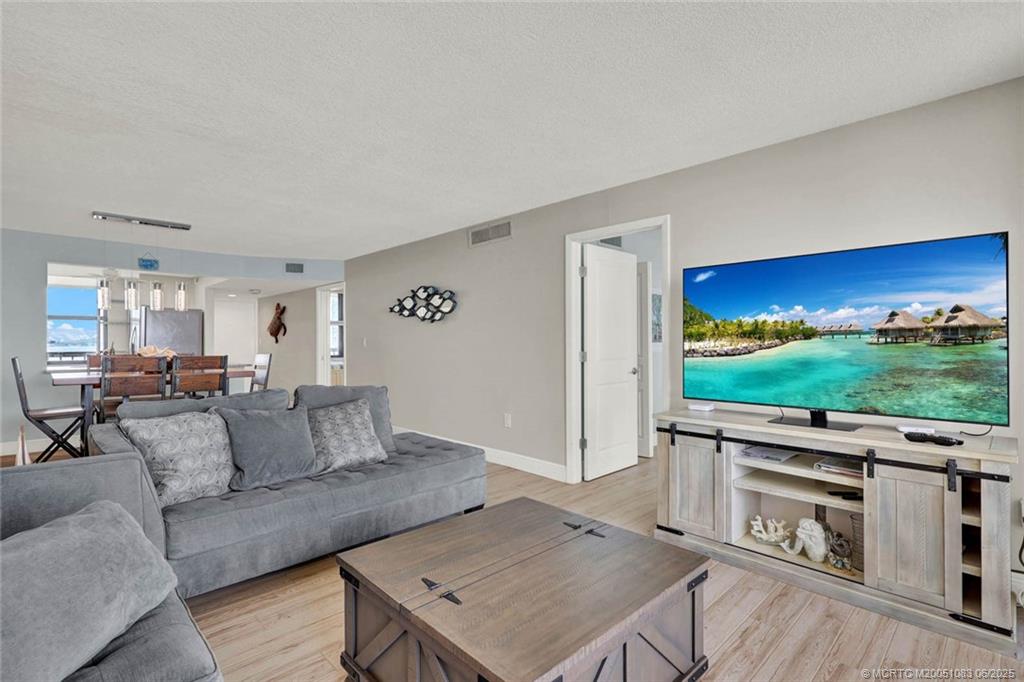 10600 South Ocean Drive, Unit 802 Jensen Beach, FL 34957 - Photo 17 of 39 a living room with furniture and a flat screen tv