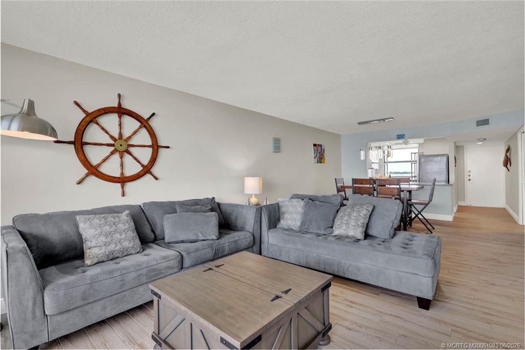 10600 South Ocean Drive, Unit 802 Jensen Beach, FL 34957 - Photo 18 of 39 a living room with furniture and a large window