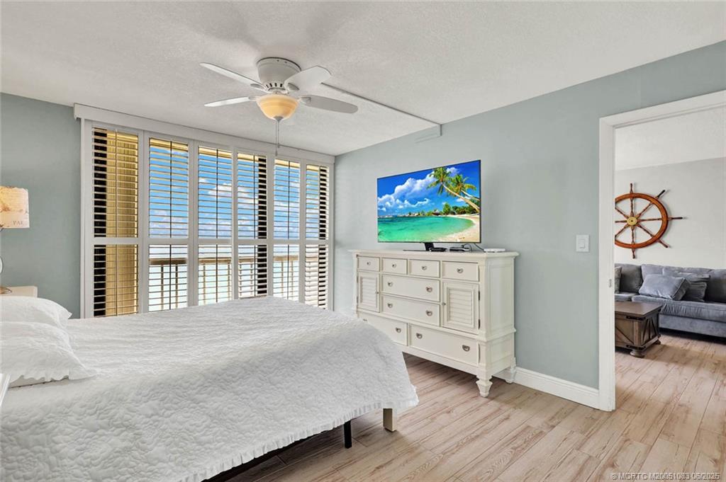 10600 South Ocean Drive, Unit 802 Jensen Beach, FL 34957 - Photo 19 of 39 a bedroom with a bed and a flat screen tv