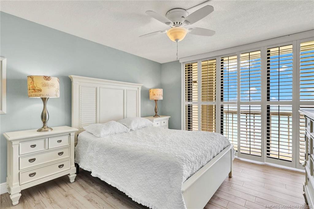 10600 South Ocean Drive, Unit 802 Jensen Beach, FL 34957 - Photo 20 of 39 a bedroom with a bed and a chandelier