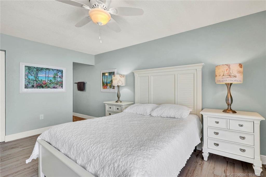 10600 South Ocean Drive, Unit 802 Jensen Beach, FL 34957 - Photo 21 of 39 a bedroom with a bed and a chandelier