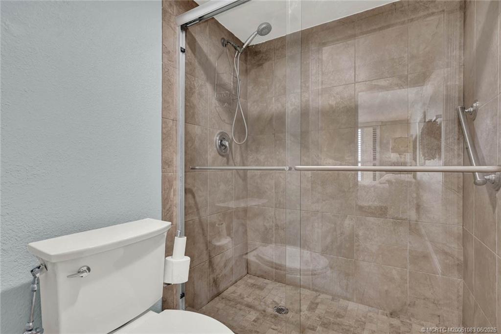 10600 South Ocean Drive, Unit 802 Jensen Beach, FL 34957 - Photo 24 of 39 a bathroom with a shower a toilet and a sink