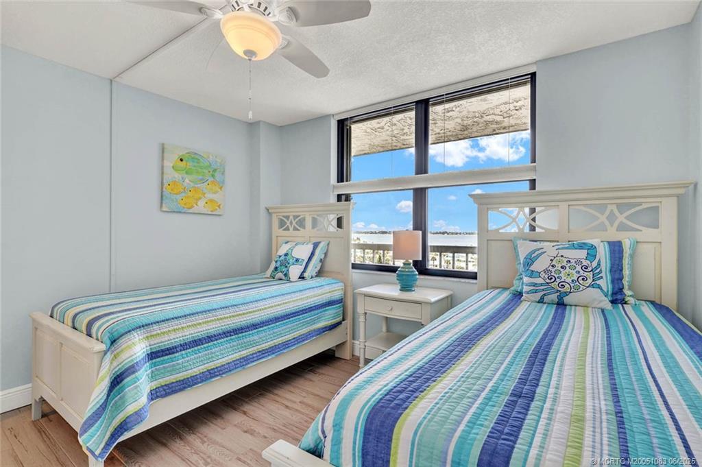 10600 South Ocean Drive, Unit 802 Jensen Beach, FL 34957 - Photo 26 of 39 a spacious bedroom with a bed and wooden floor