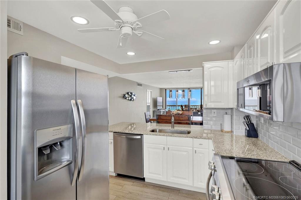 10600 South Ocean Drive, Unit 802 Jensen Beach, FL 34957 - Photo 10 of 39 a kitchen with refrigerator and stove
