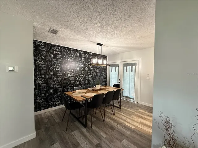 a view of a dining room with furniture and window
