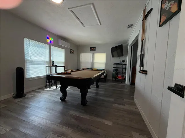 a room with furniture a window and wooden floor