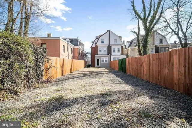 a view of a house with a yard covered in snow