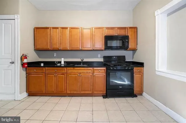 a kitchen with a sink and a stove top oven