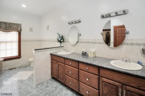 a bathroom with a double vanity sink and a mirror