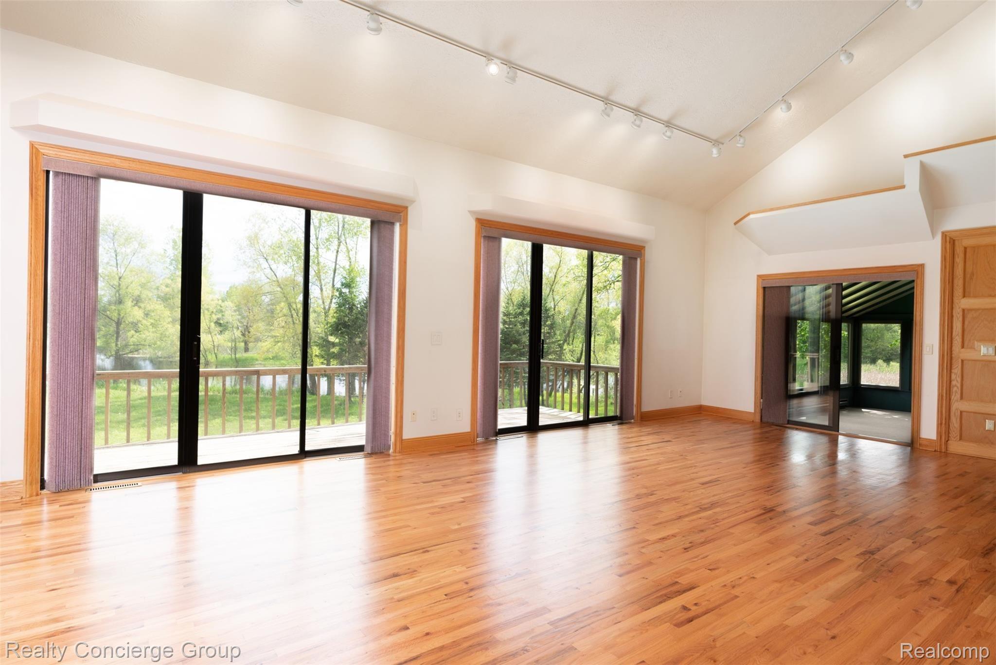 Stunning views of the pond, natural lighting and track lighting make this great room the ultimate place to spend your time in 