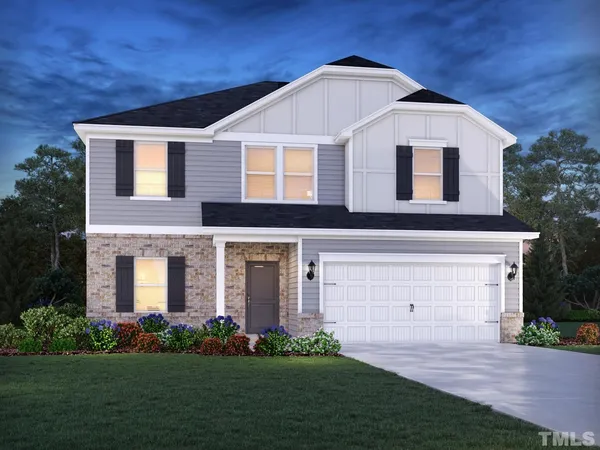 a front view of a house with a garden and plants