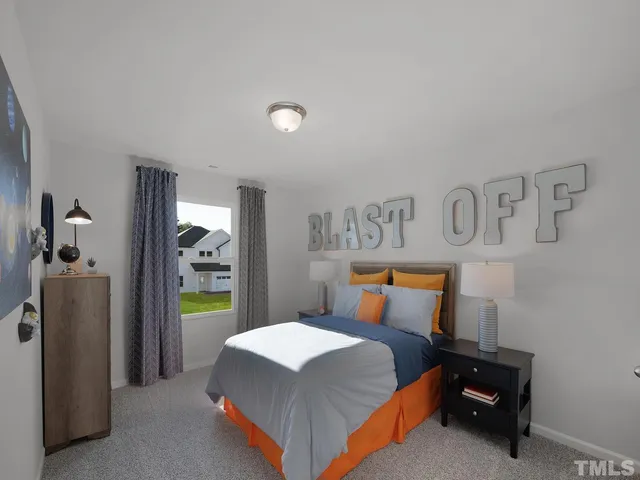 a bedroom with a bed and a lamp